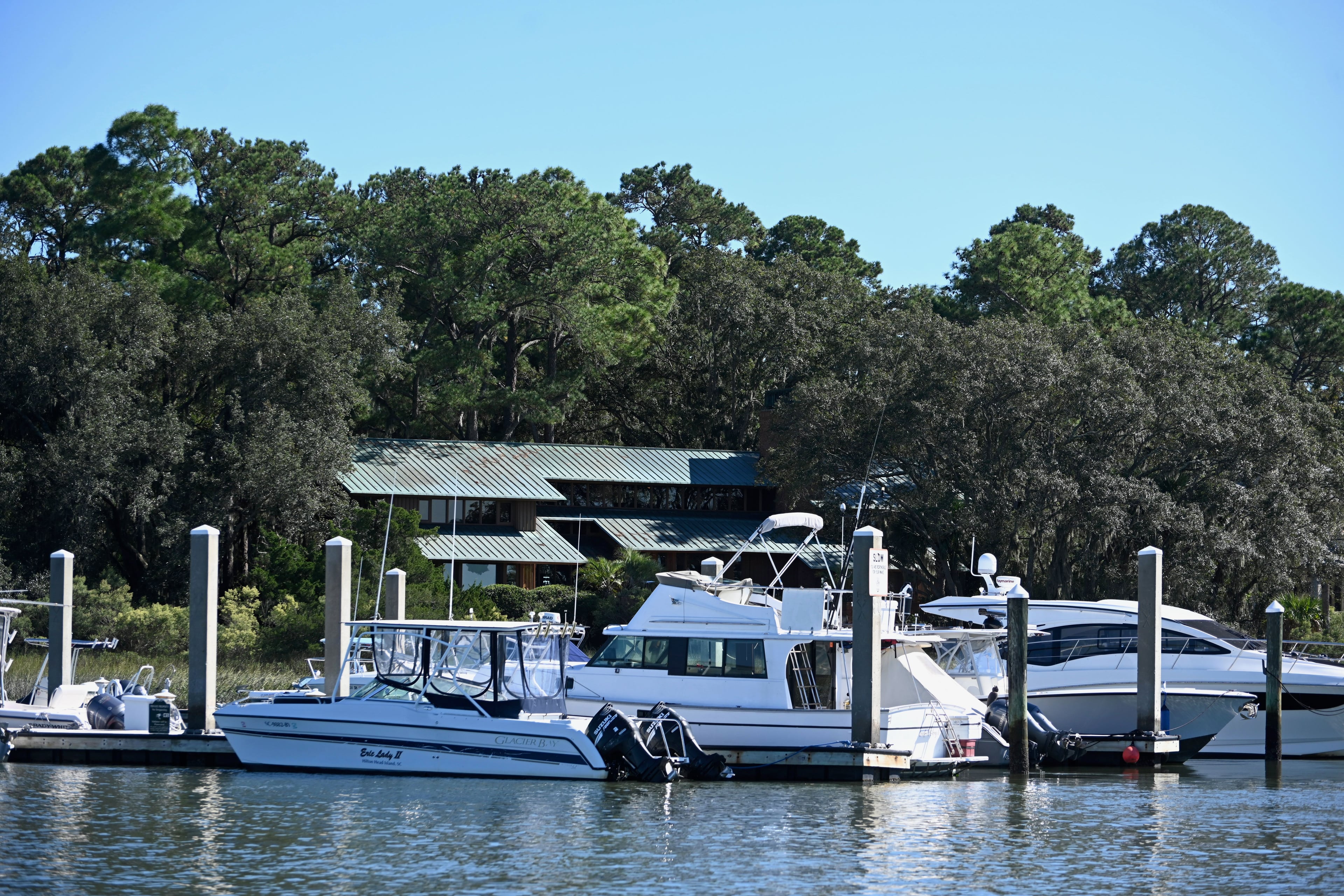 Boats moored at a Hilton Head marina under live oaks