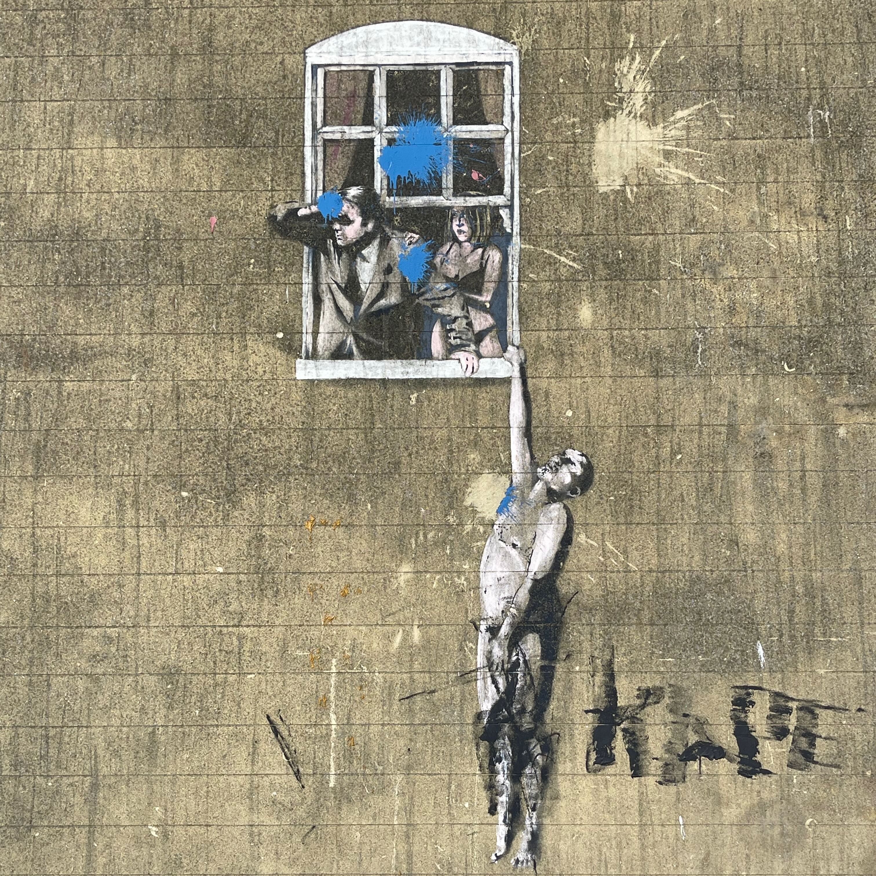 Banksy's Well Hung Lover mural on a Park Street wall in Bristol.