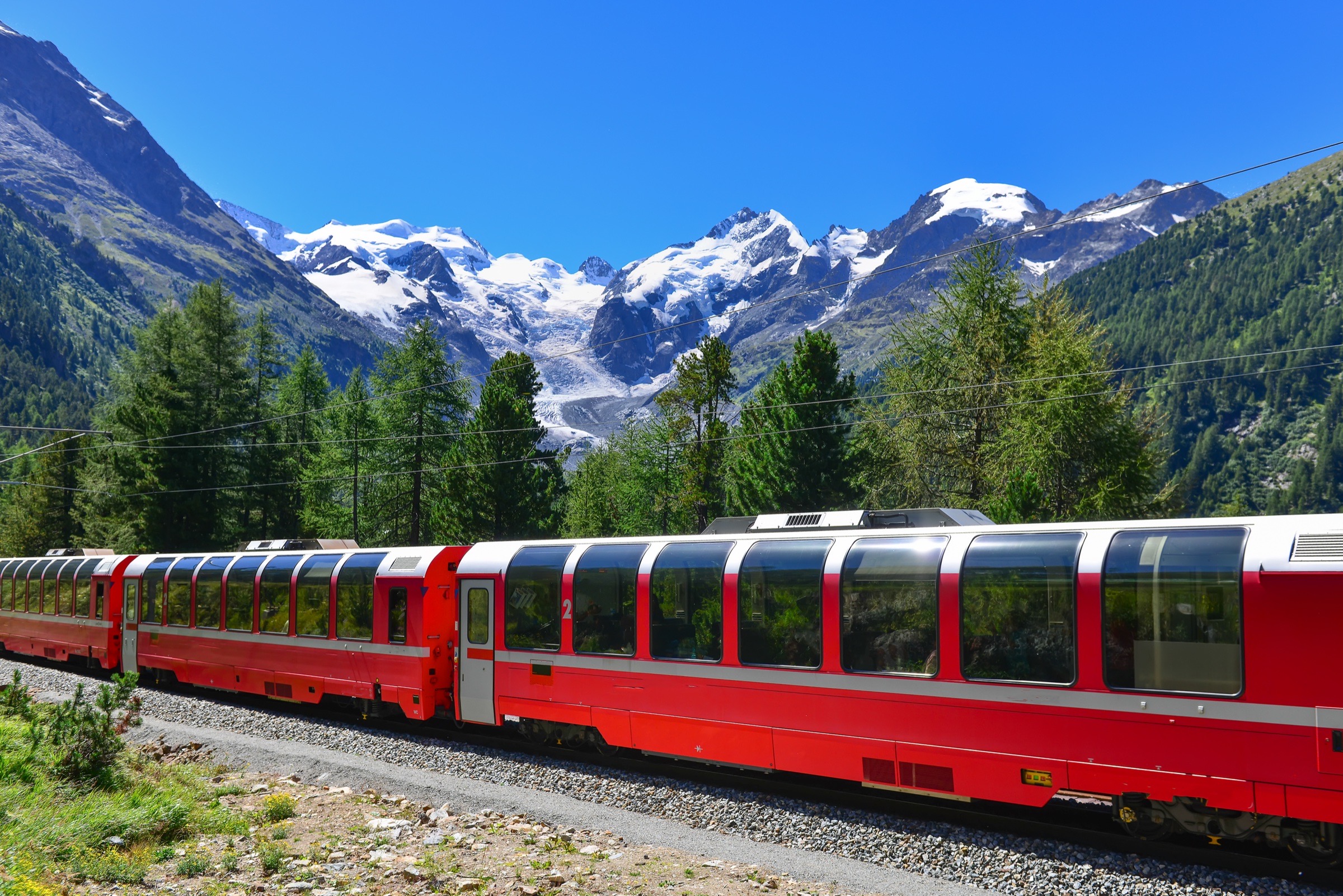 A red Bernina Express train crossing the Swiss Alps.