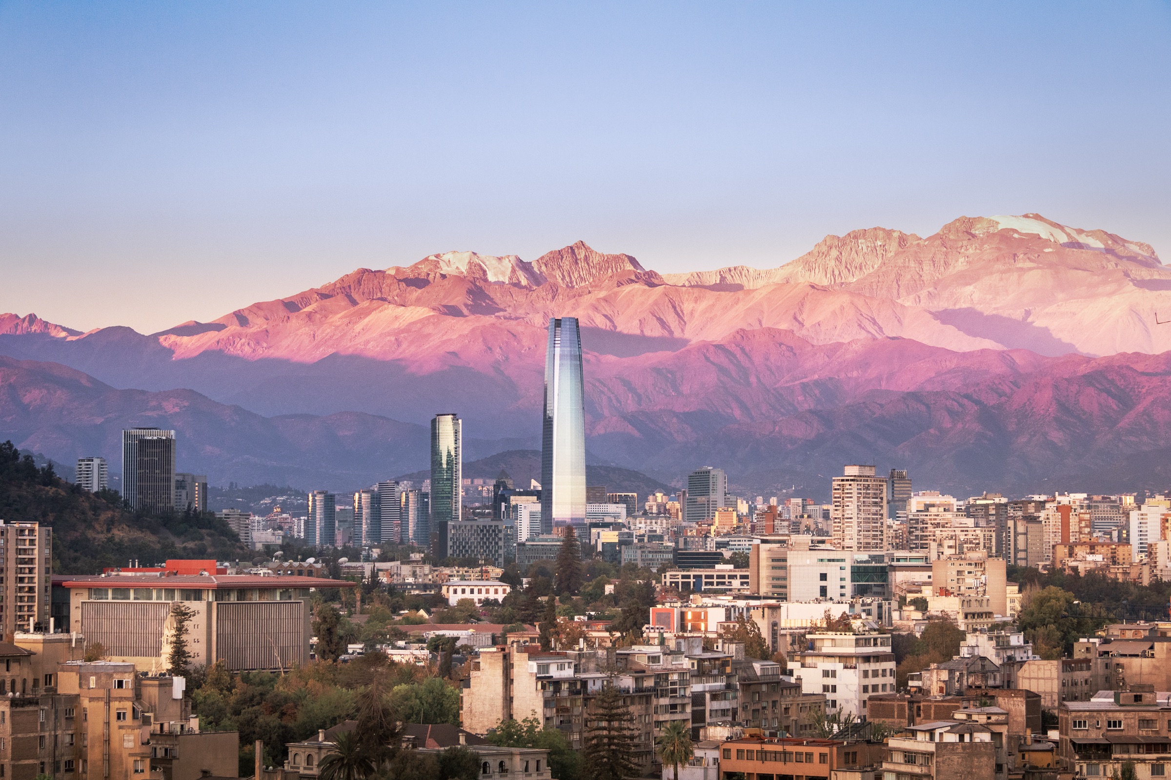 Santiago skyline at sunset with the Andes in the distance.
