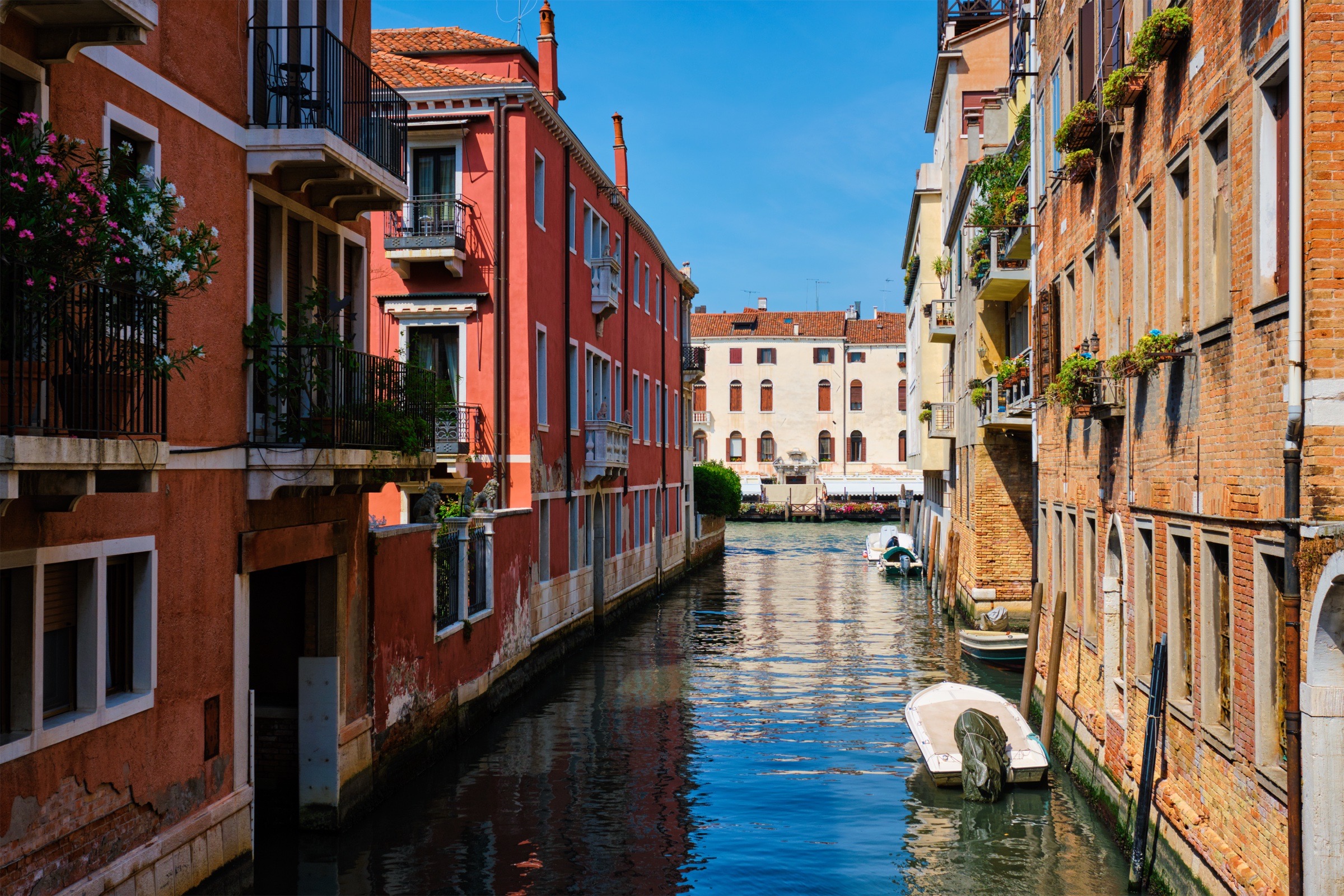A narrow Venice canal with a gondola.