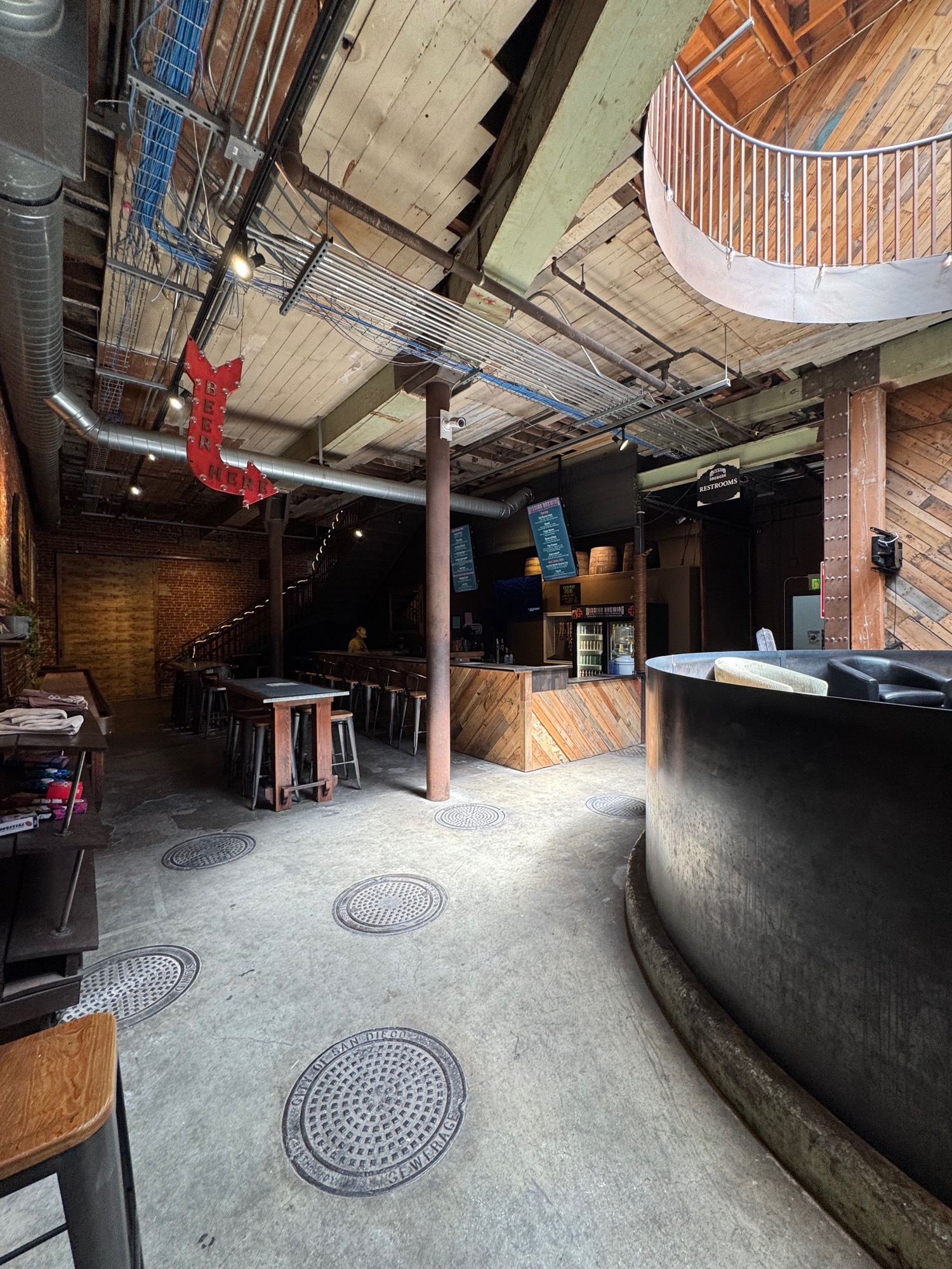 Wide shot of the brewhouse floor with manhole covers set in.